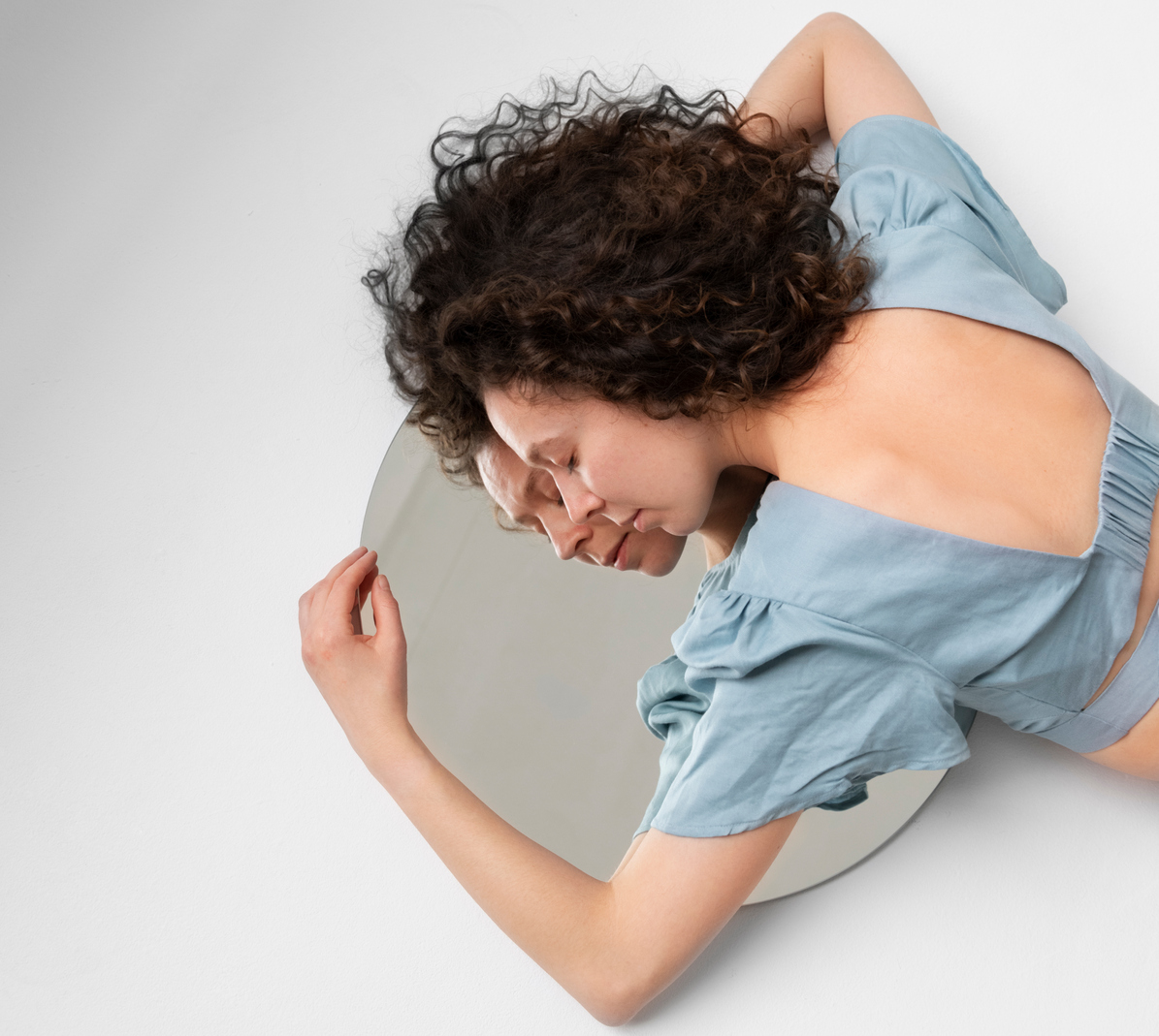 high-angle-woman-laying-mirror.jpg