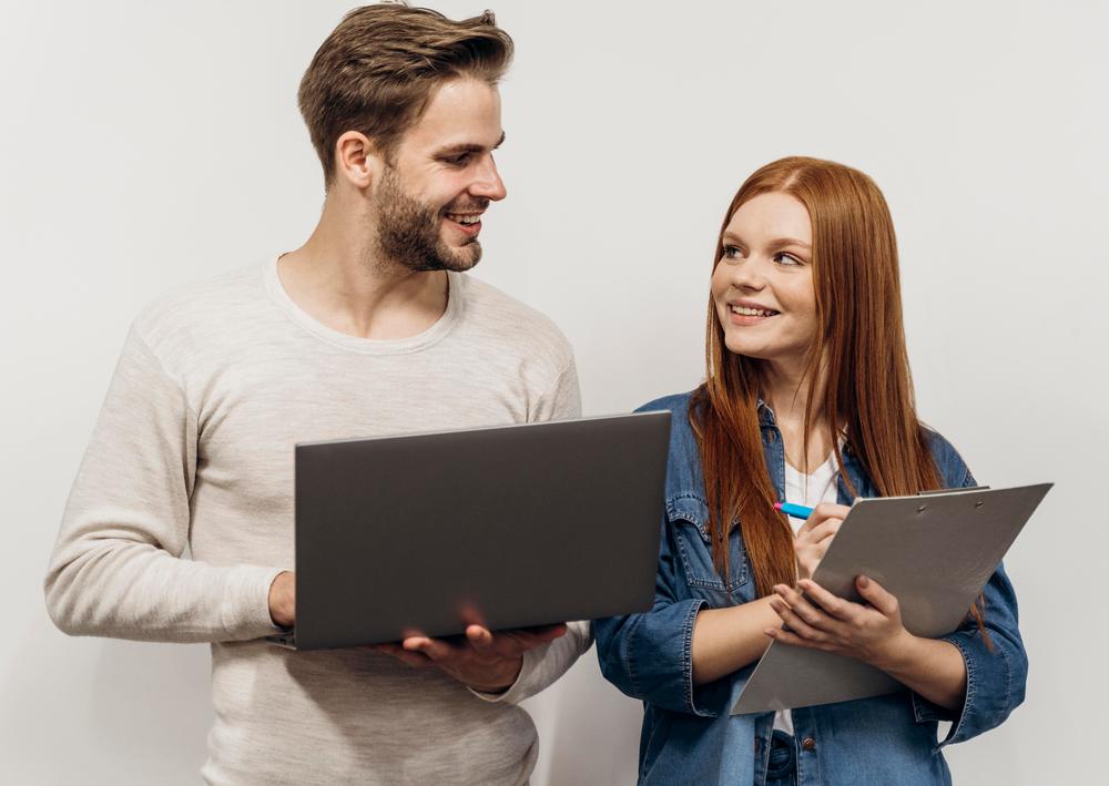 redhead-businesswoman-working-laptop-with-her-coworker.jpg