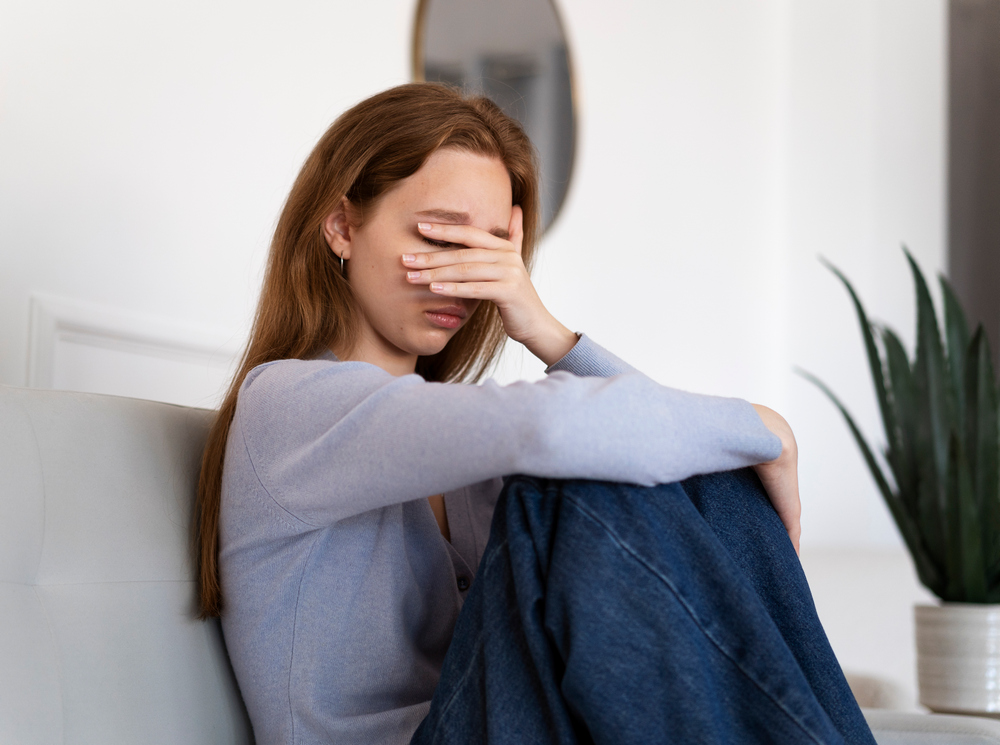side-view-anxious-woman-sitting-couch.jpg